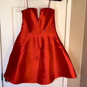 Small Gb dress with v neck and thin red straps.